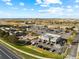 This aerial view shows a commercial development with a variety of retail and restaurant spaces, surrounded by parking at 18633 Stroh Rd # 2-104, Parker, CO 80134
