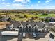 An aerial view of townhome-style residences showcases the property's prime location near green spaces and natural landscaping at 18633 Stroh Rd # 2-104, Parker, CO 80134
