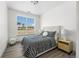 Comfortable bedroom featuring a large window, modern bedding, and stylish furniture at 18633 Stroh Rd # 2-104, Parker, CO 80134