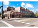 A red brick commercial building features a street-level storefront and office space, with large windows and detailed architecture at 18633 Stroh Rd # 2-104, Parker, CO 80134