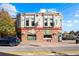 A quaint commercial building with brick and light siding, street-level retail, and well-maintained landscaping provides a welcoming facade at 18633 Stroh Rd # 2-104, Parker, CO 80134