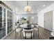 Open dining area with modern chandelier, sliding glass doors and view of the living room at 18633 Stroh Rd # 2-104, Parker, CO 80134