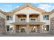 Charming two-story townhome featuring stone accents, a cozy porch, and a private balcony at 18633 Stroh Rd # 2-104, Parker, CO 80134