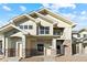 Charming two-story townhome featuring stone accents, a cozy porch, and a private balcony at 18633 Stroh Rd # 2-104, Parker, CO 80134