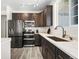 Well-equipped kitchen with stainless steel appliances, dark cabinetry, and marble countertops at 18633 Stroh Rd # 2-104, Parker, CO 80134