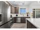 Stylish kitchen with stainless steel appliances, dark wood cabinets, and bright countertops at 18633 Stroh Rd # 2-104, Parker, CO 80134