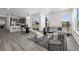 Open-concept living room with gray flooring, modern furniture, and large windows providing natural light at 18633 Stroh Rd # 2-104, Parker, CO 80134