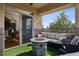 Cozy covered balcony with a fire pit, comfortable seating, and seamless transition to the indoor dining area at 9456 Rockhurst St # F, Highlands Ranch, CO 80129