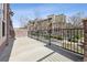 Spacious balcony with black metal railing, offering views of the surrounding neighborhood and outdoor living space at 9456 Rockhurst St # F, Highlands Ranch, CO 80129