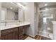 Bathroom features modern vanity with a large mirror and glass enclosed shower at 9456 Rockhurst St # F, Highlands Ranch, CO 80129