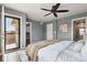 Cozy bedroom showcases wood floors, a ceiling fan, and access to a private balcony at 9456 Rockhurst St # F, Highlands Ranch, CO 80129