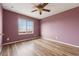 Empty bedroom showcases hardwood floors, a ceiling fan, and natural light from a window at 9456 Rockhurst St # F, Highlands Ranch, CO 80129