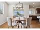 Charming dining room featuring a modern light fixture, a round wooden table, and comfortable chairs for Gathering meals at 9456 Rockhurst St # F, Highlands Ranch, CO 80129