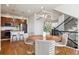 Inviting dining area with a round table, stylish chairs, and views of the kitchen and staircase at 9456 Rockhurst St # F, Highlands Ranch, CO 80129