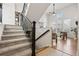 Welcoming entryway featuring a staircase with wrought iron railings and views of the living area at 9456 Rockhurst St # F, Highlands Ranch, CO 80129