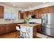 Modern kitchen features a center island, stainless steel appliances, granite counters, and pendant lighting at 9456 Rockhurst St # F, Highlands Ranch, CO 80129