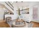 Inviting living room featuring comfortable seating, a stylish area rug, and access to the upper level via an open staircase at 9456 Rockhurst St # F, Highlands Ranch, CO 80129