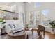 Stylish living room with high ceilings, large windows, modern furnishings, and hardwood floors at 9456 Rockhurst St # F, Highlands Ranch, CO 80129