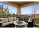 Covered patio with comfortable seating and a fire pit, perfect for outdoor relaxation and entertaining at 9456 Rockhurst St # F, Highlands Ranch, CO 80129