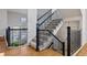 Open staircase with iron railings and carpeted steps, showcasing a bright and airy transition between floors at 9456 Rockhurst St # F, Highlands Ranch, CO 80129