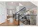 Elegant staircase featuring dark metal railings and carpeted steps, complemented by hardwood flooring in the entryway at 9456 Rockhurst St # F, Highlands Ranch, CO 80129