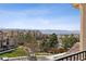 Scenic view from the home overlooking lush greenery, buildings, and distant mountains under a bright sky at 9456 Rockhurst St # F, Highlands Ranch, CO 80129