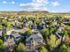 Overhead aerial view of the home and neighborhood, showcasing its prime location, beautiful landscape, and mountain views at 6155 Puma Pt, Lone Tree, CO 80124