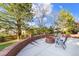 Backyard patio area featuring a wood-burning fire pit with beautiful landscaping views at 6155 Puma Pt, Lone Tree, CO 80124