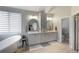 Bright bathroom featuring double vanity, stand alone tub, and lots of natural light at 6155 Puma Pt, Lone Tree, CO 80124