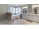 Bathroom with stand alone tub, glass shower, double vanity with sleek counters and modern fixtures at 6155 Puma Pt, Lone Tree, CO 80124