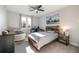 Bedroom featuring a bed, desk, grey carpets, ceiling fan, and window view at 6155 Puma Pt, Lone Tree, CO 80124