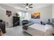 Bedroom featuring a bed, dresser, dark carpets, ceiling fan, and view at 6155 Puma Pt, Lone Tree, CO 80124