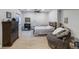 Cozy bedroom showcasing neutral tones, ceiling fan, and complementing sitting area at 6155 Puma Pt, Lone Tree, CO 80124