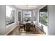 Cozy breakfast nook with bay window and round table, bathed in natural light, perfect for casual dining at 6155 Puma Pt, Lone Tree, CO 80124