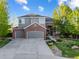 Beautiful two-story home with a well-maintained lawn, mature trees, and a spacious three car driveway at 6155 Puma Pt, Lone Tree, CO 80124