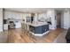 Bright kitchen with white cabinetry, stainless steel appliances, and a spacious island with barstool seating at 6155 Puma Pt, Lone Tree, CO 80124