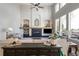 Spacious living room with high ceilings, a fireplace, and large windows offering plenty of natural light at 6155 Puma Pt, Lone Tree, CO 80124
