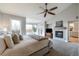 Spacious main bedroom with a fireplace, ceiling fan and large windows for lots of natural light at 6155 Puma Pt, Lone Tree, CO 80124