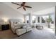 Large main bedroom featuring large windows with views, ceiling fan, and carpet flooring at 6155 Puma Pt, Lone Tree, CO 80124