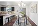 Modern dining area with a black table and sleek kitchen at 3288 S Dudley Ct, Lakewood, CO 80227