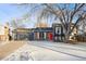 Ranch style home with a red door, gray garage, and mature trees at 3288 S Dudley Ct, Lakewood, CO 80227