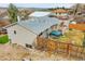 A well maintained backyard including a deck, a hot tub, and a fenced in yard at 228 Birch Ave, Castle Rock, CO 80104