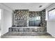 Basement featuring a stone fireplace, a stone accent wall, and a built-in fish tank at 228 Birch Ave, Castle Rock, CO 80104