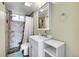 Cozy bathroom featuring a tiled shower, updated vanity, and a bright blue rug to accent the room's features at 228 Birch Ave, Castle Rock, CO 80104