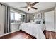 Bedroom featuring hardwood floors, two windows, and white decor at 228 Birch Ave, Castle Rock, CO 80104