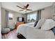 Comfortable bedroom with a ceiling fan, wood floors, and two windows at 228 Birch Ave, Castle Rock, CO 80104