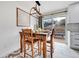 Dining room with a wooden table and chairs that sit atop an area rug next to a sliding glass door to the deck at 228 Birch Ave, Castle Rock, CO 80104