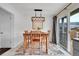 A dining room with a wood table and chairs, an overhead light fixture, and a sliding glass door to the deck at 228 Birch Ave, Castle Rock, CO 80104