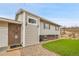 Charming exterior featuring brick accents, freshly cut grass, and a welcoming stone path leading to the front door at 228 Birch Ave, Castle Rock, CO 80104