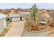 Exterior shot of the front of a home with a long driveway leading up to the garage at 228 Birch Ave, Castle Rock, CO 80104